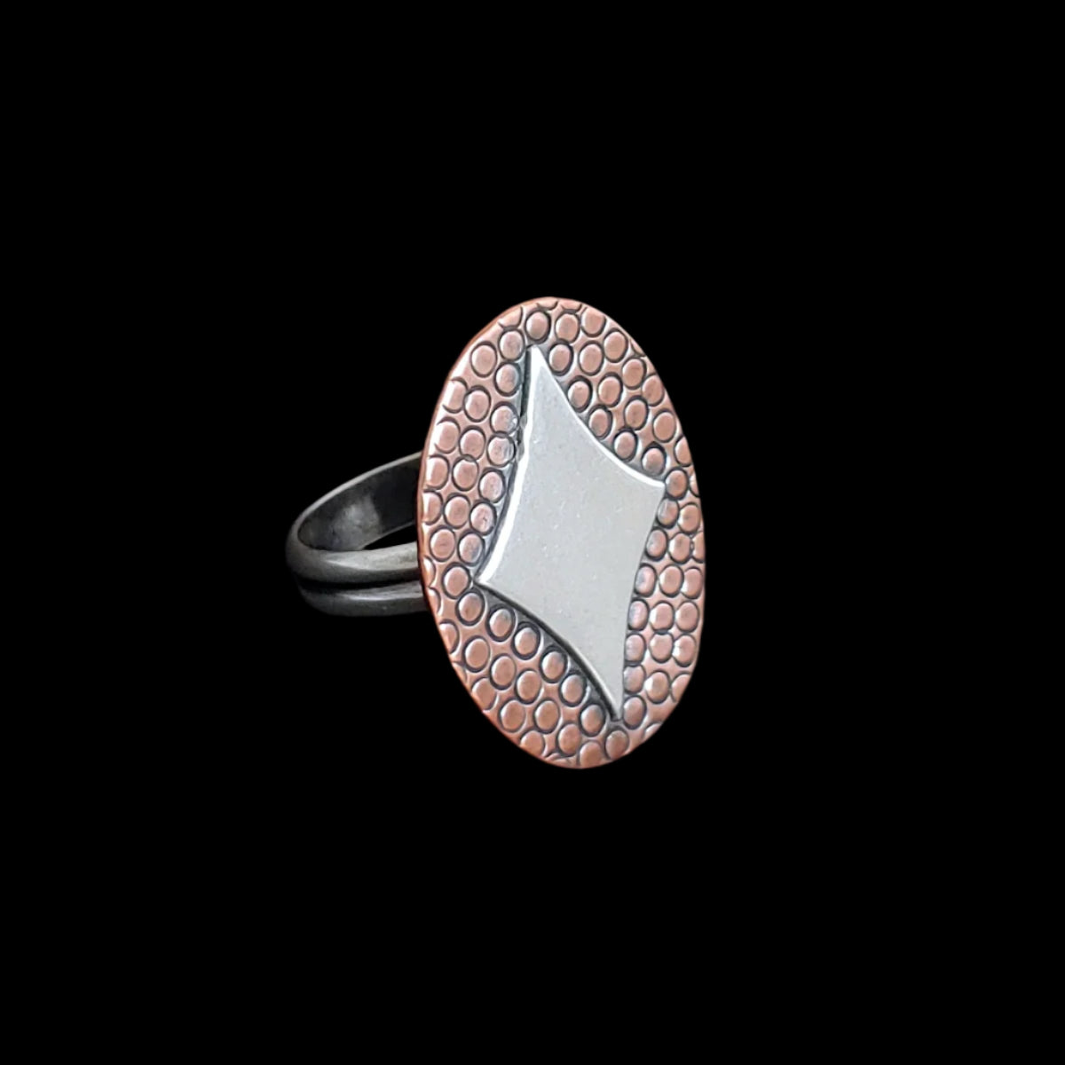 Handmade retro inspired sterling silver ring with a diamond shaped star on copper and sterling silver band