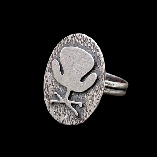 Mid century modern Swan Chair ring handmade in sterling silver which is perfect as a 17th wedding anniversary gift of furniture as shown on a black background
