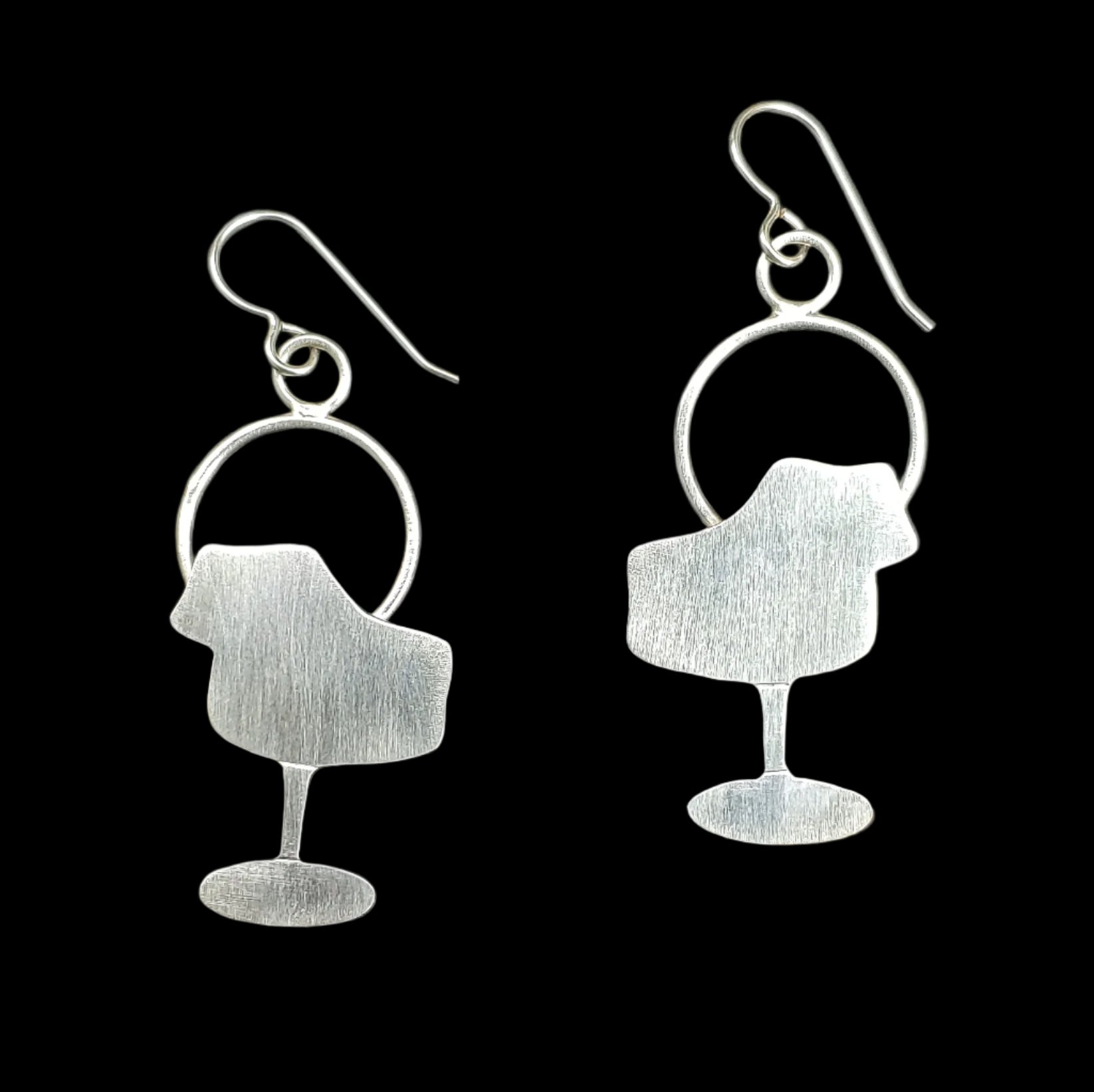 Mid century modern tulip chair earrings handmade in sterling silver which are perfect for the 17th wedding anniversary gift of furniture as shown on a black background