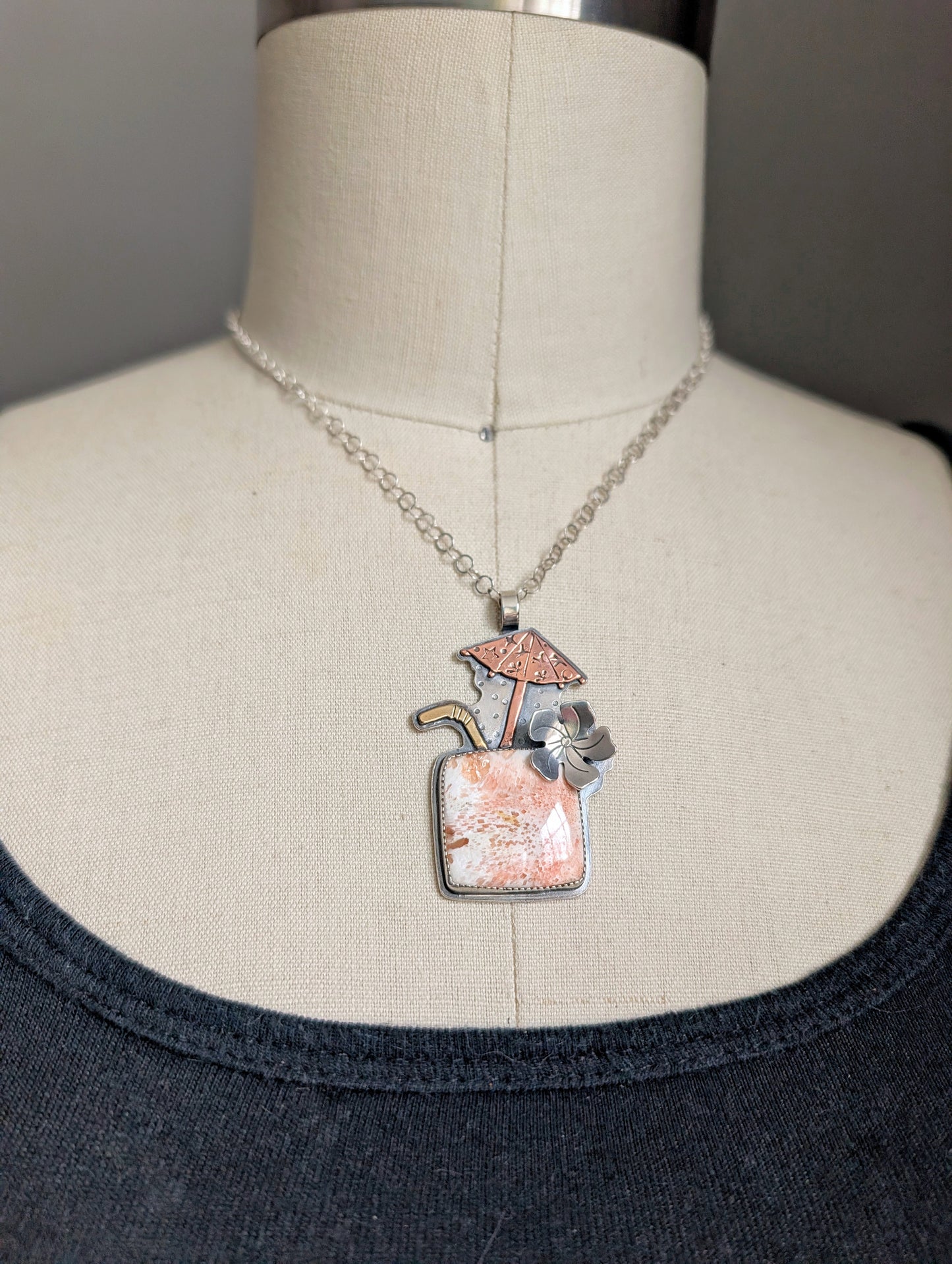 Close up shot on a bust of my Tiki Drink cocktail necklace with pink scolecite