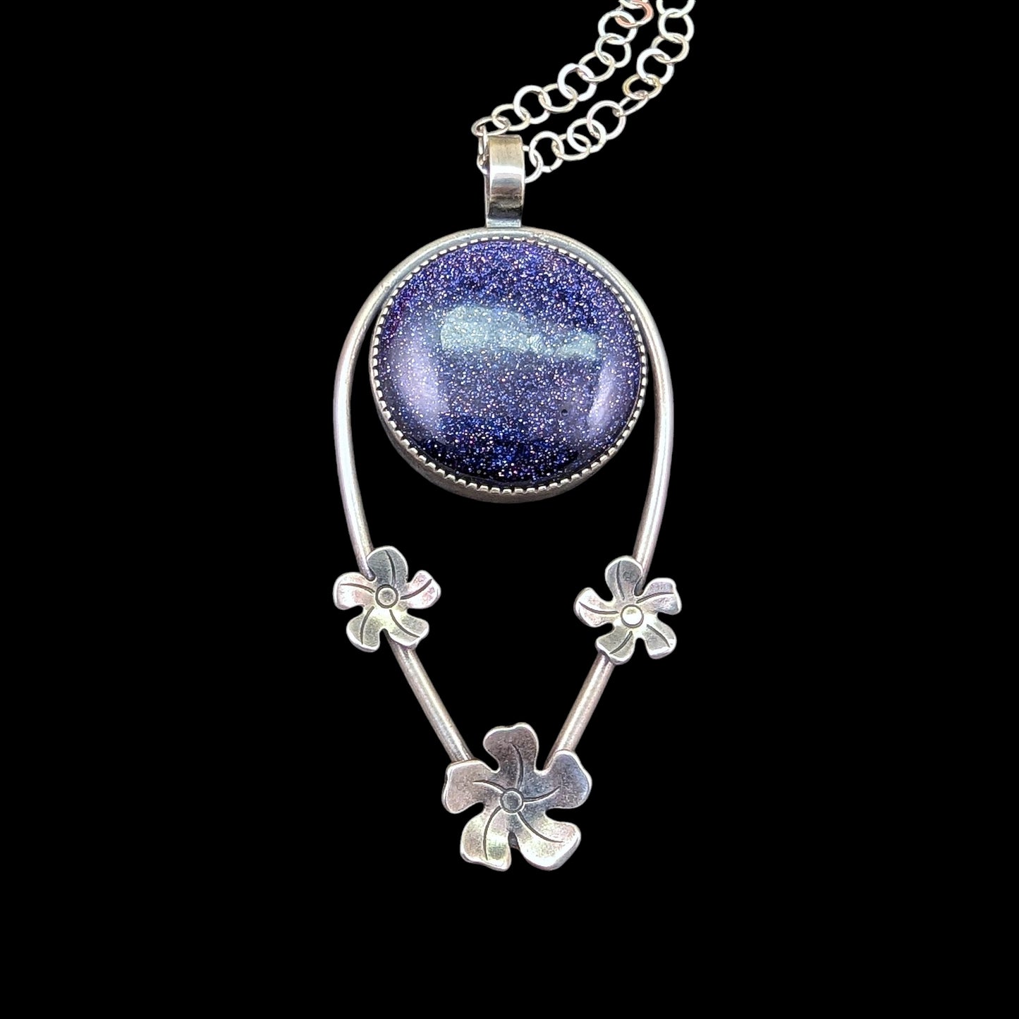 Blue goldstone sterling silver necklace with flowers on black background