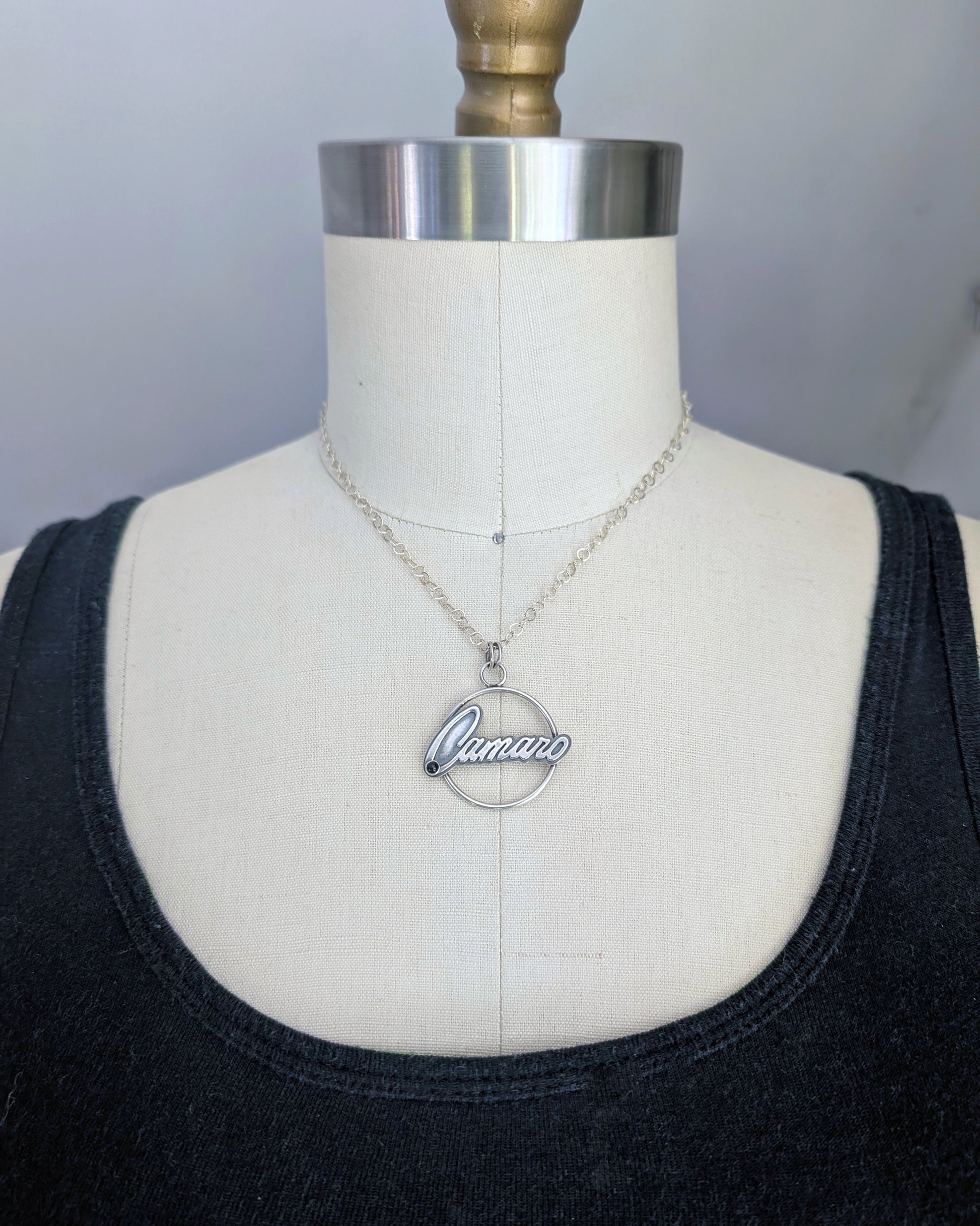 Sterling silver necklace with 'Camaro' pendant on a mannequin bust facing forwards