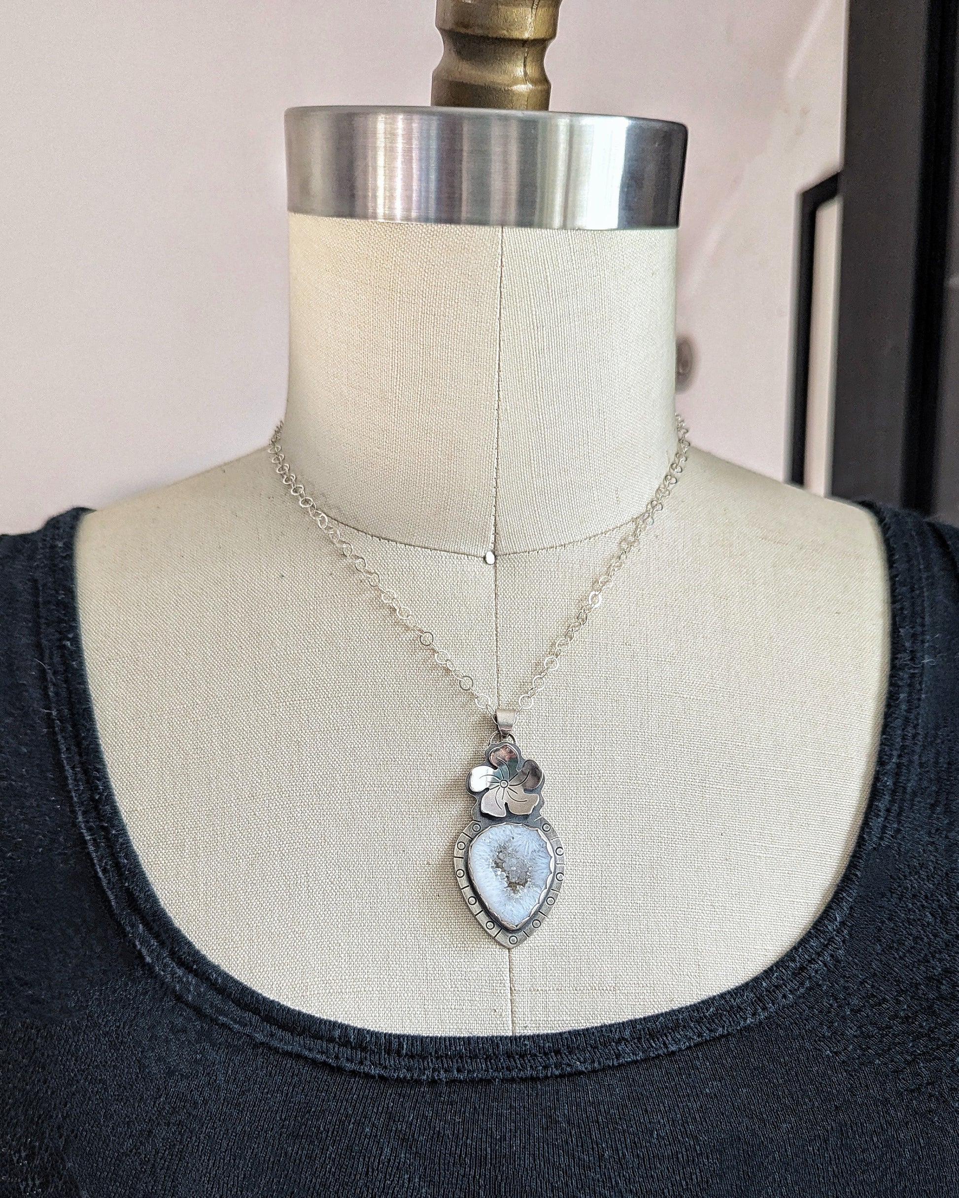 White druzy quartz necklace on a dress form