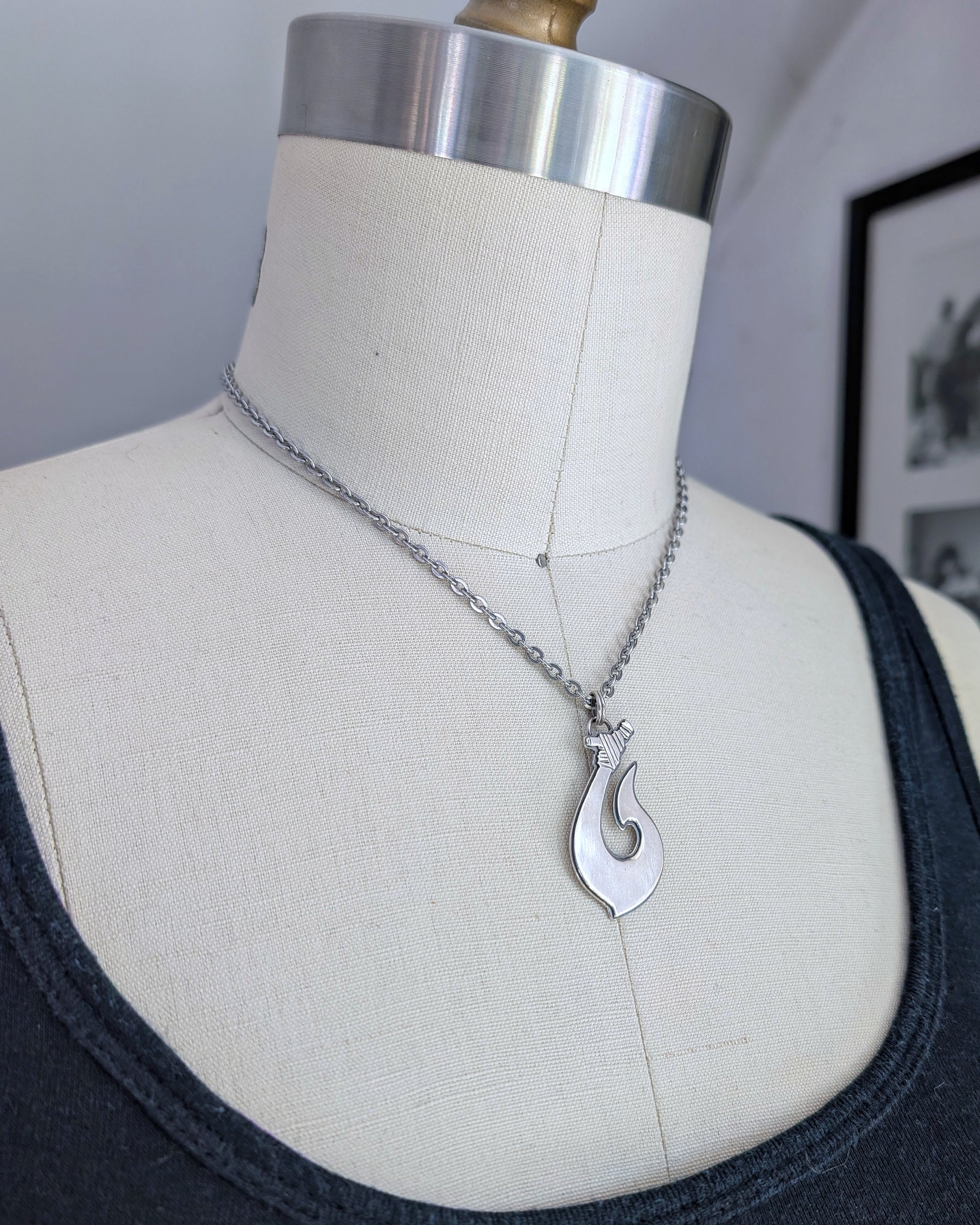 Maori Hawaiian sterling silver fish hook necklace on a mannequin side view
