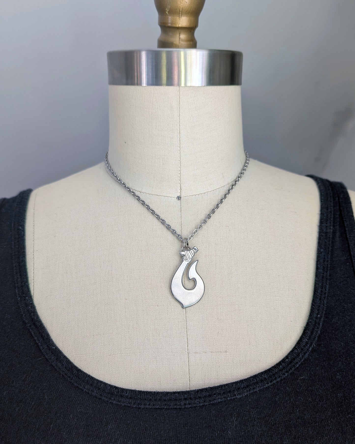 Maori Hawaiian sterling silver fish hook necklace on a mannequin front view