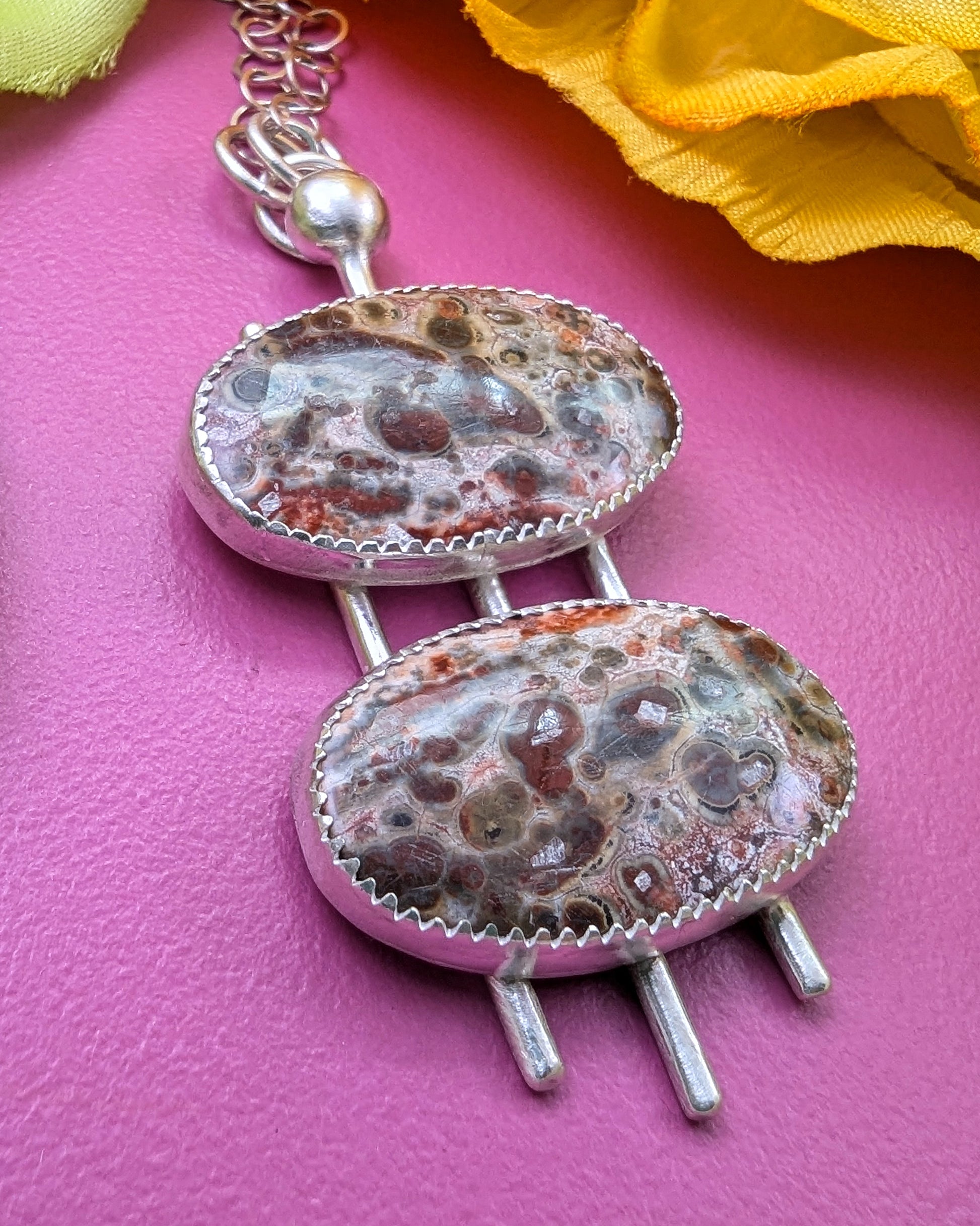 Double cherry creek jasper handmade in sterling silver on a pink background