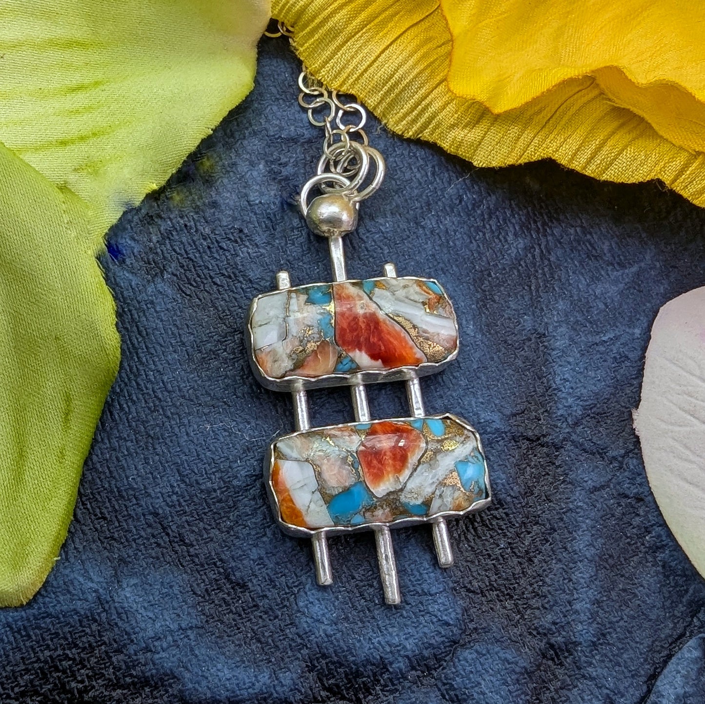 Mid century modern handmade sterling silver necklace with turquoise mosaic on a navy background