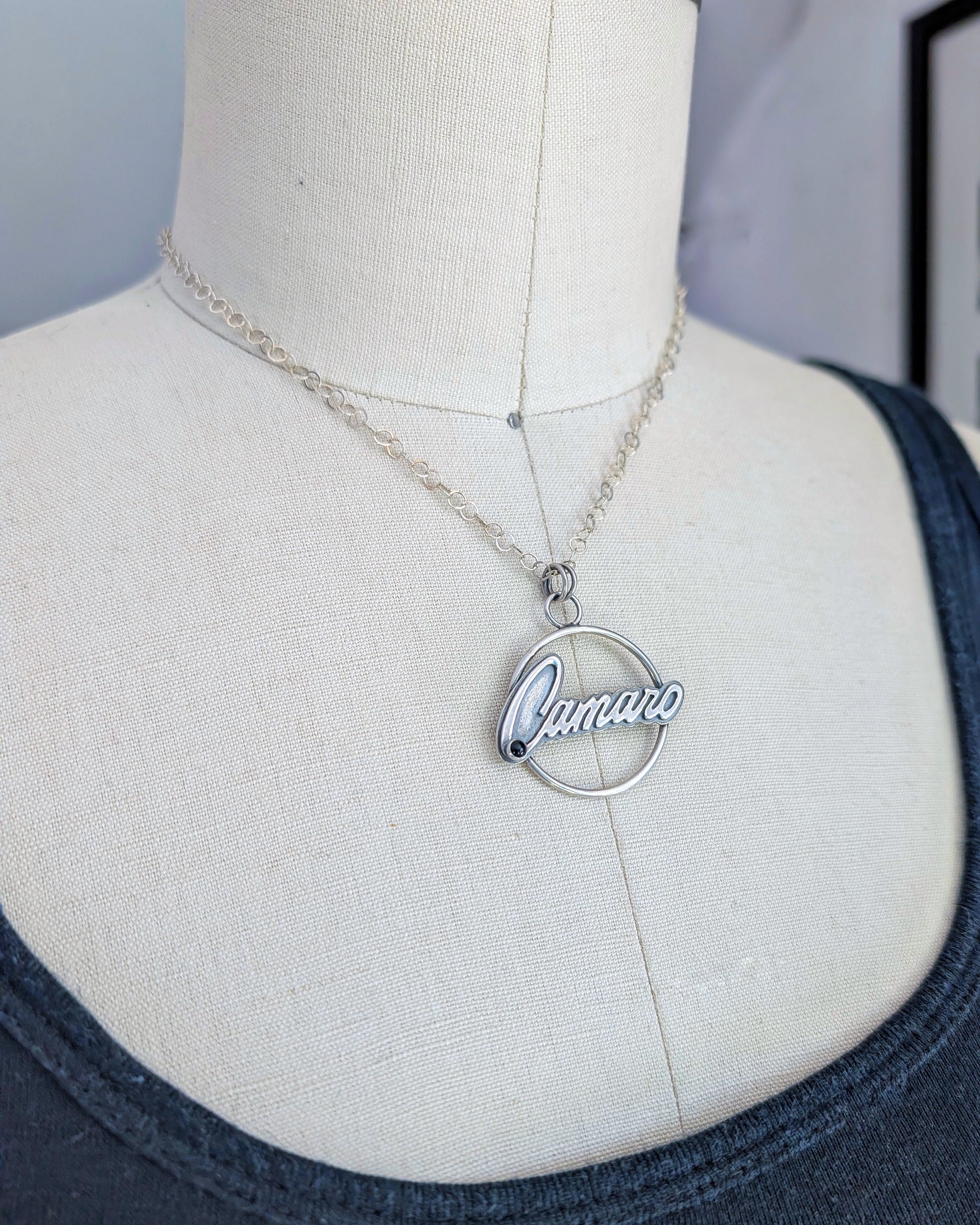 Sterling silver necklace with 'Camaro' pendant on a mannequin bust.
