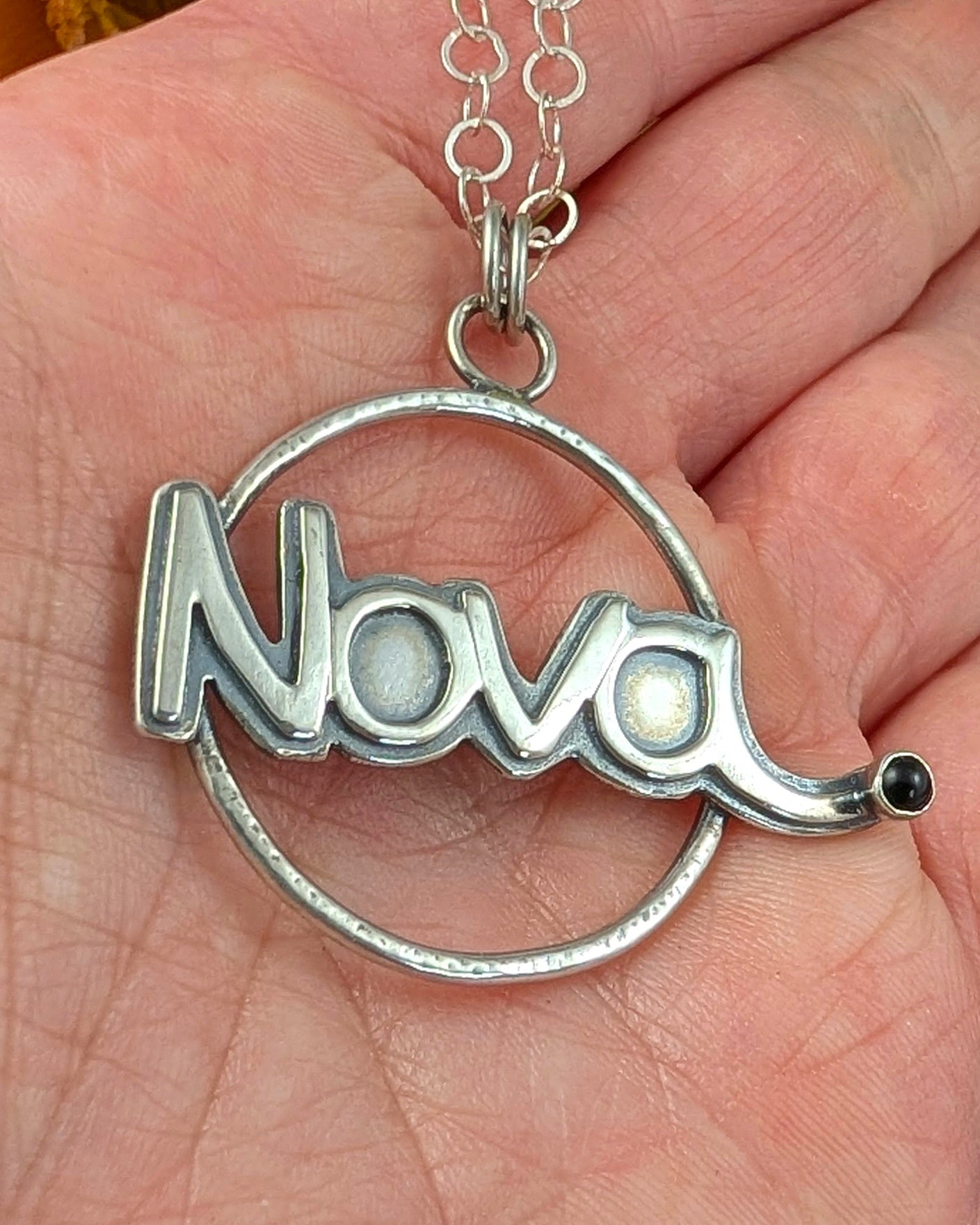 Nova necklace in sterling silver in someone's hand