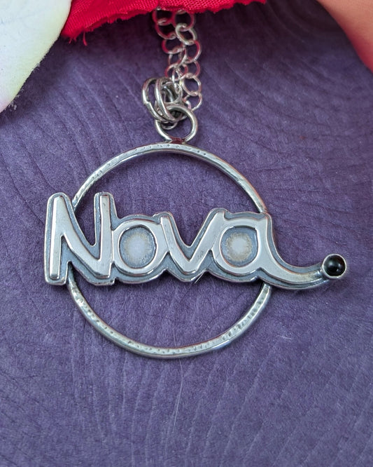 Nova necklace in sterling silver with black onyx on a purple background