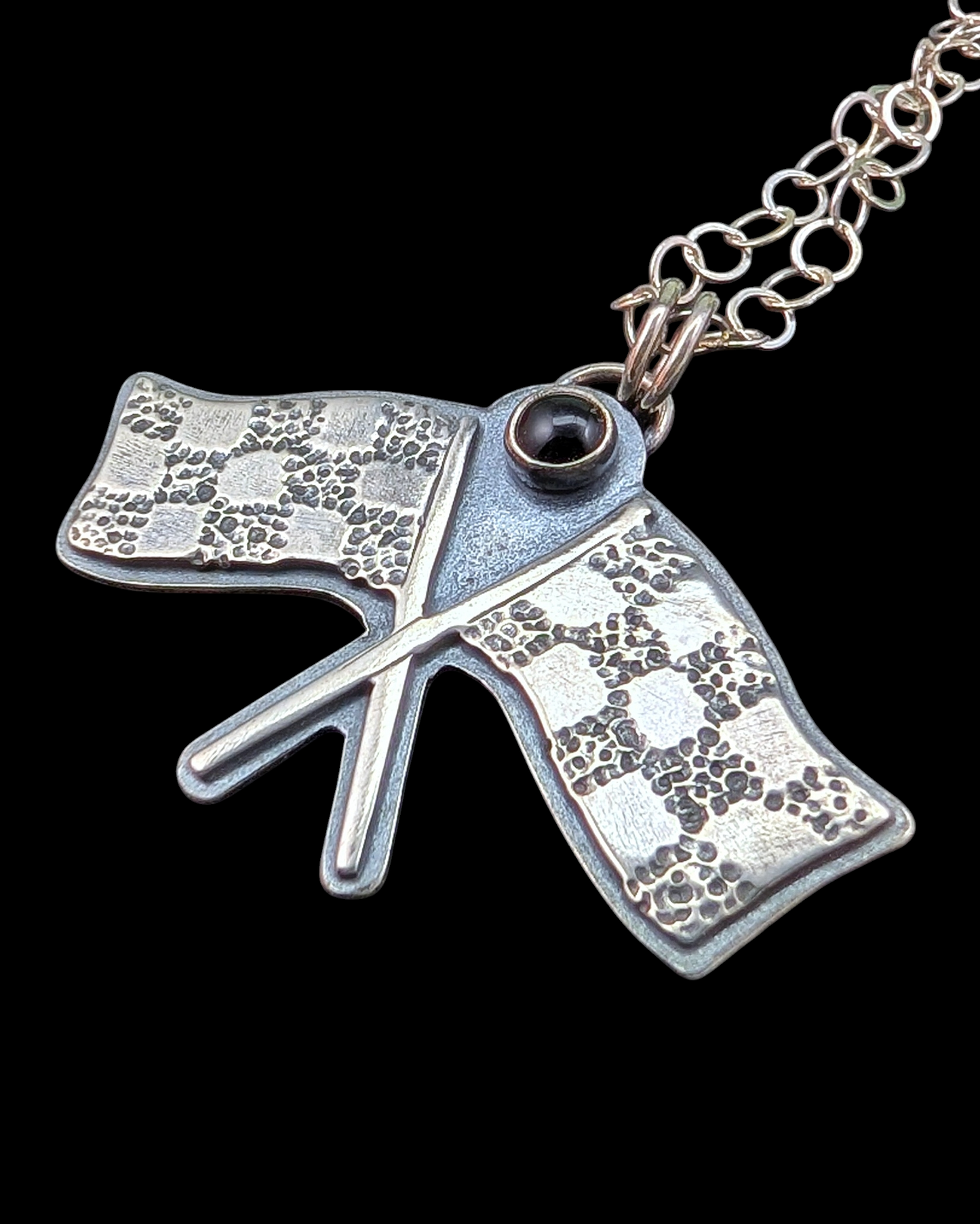 Racing flags necklace on black background