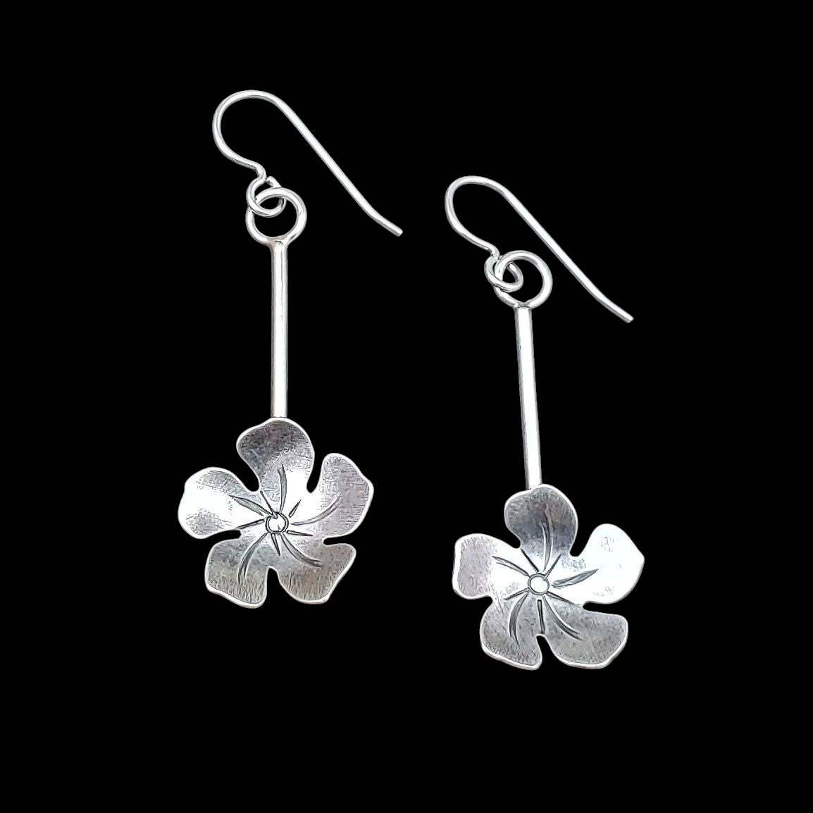 Handmade sterling silver plumeria tiki earrings.