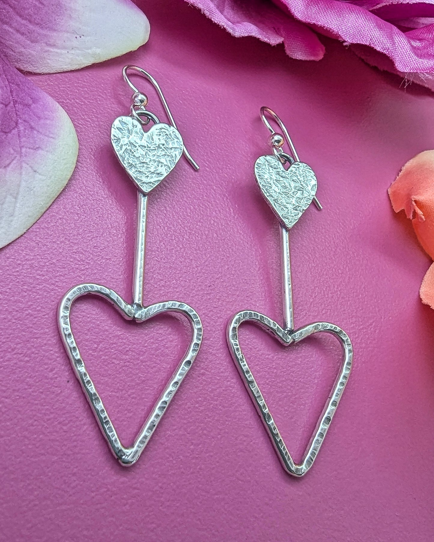 Side view of modernist sterling silver lightweight heart earrings with a retro vibe