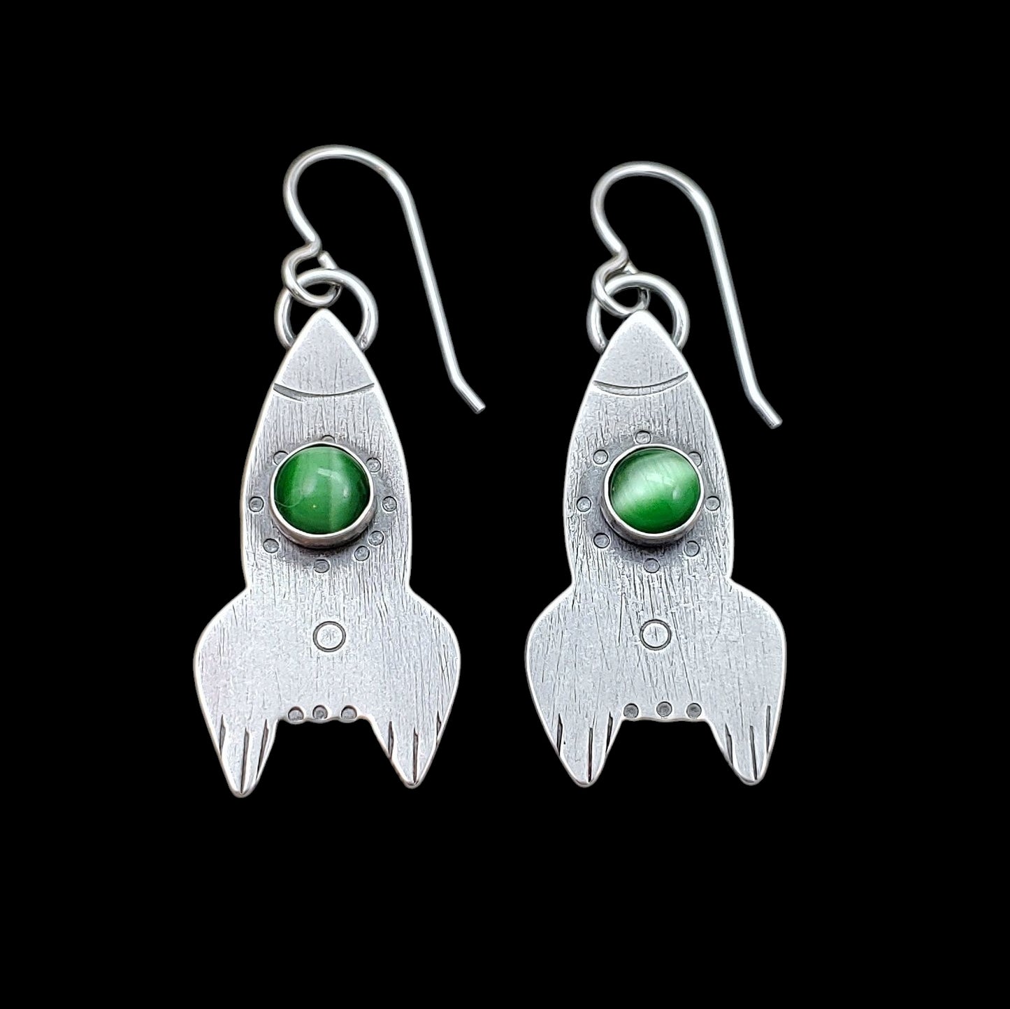 Handmade sterling silver rocket ship earrings featuring green cats eye.