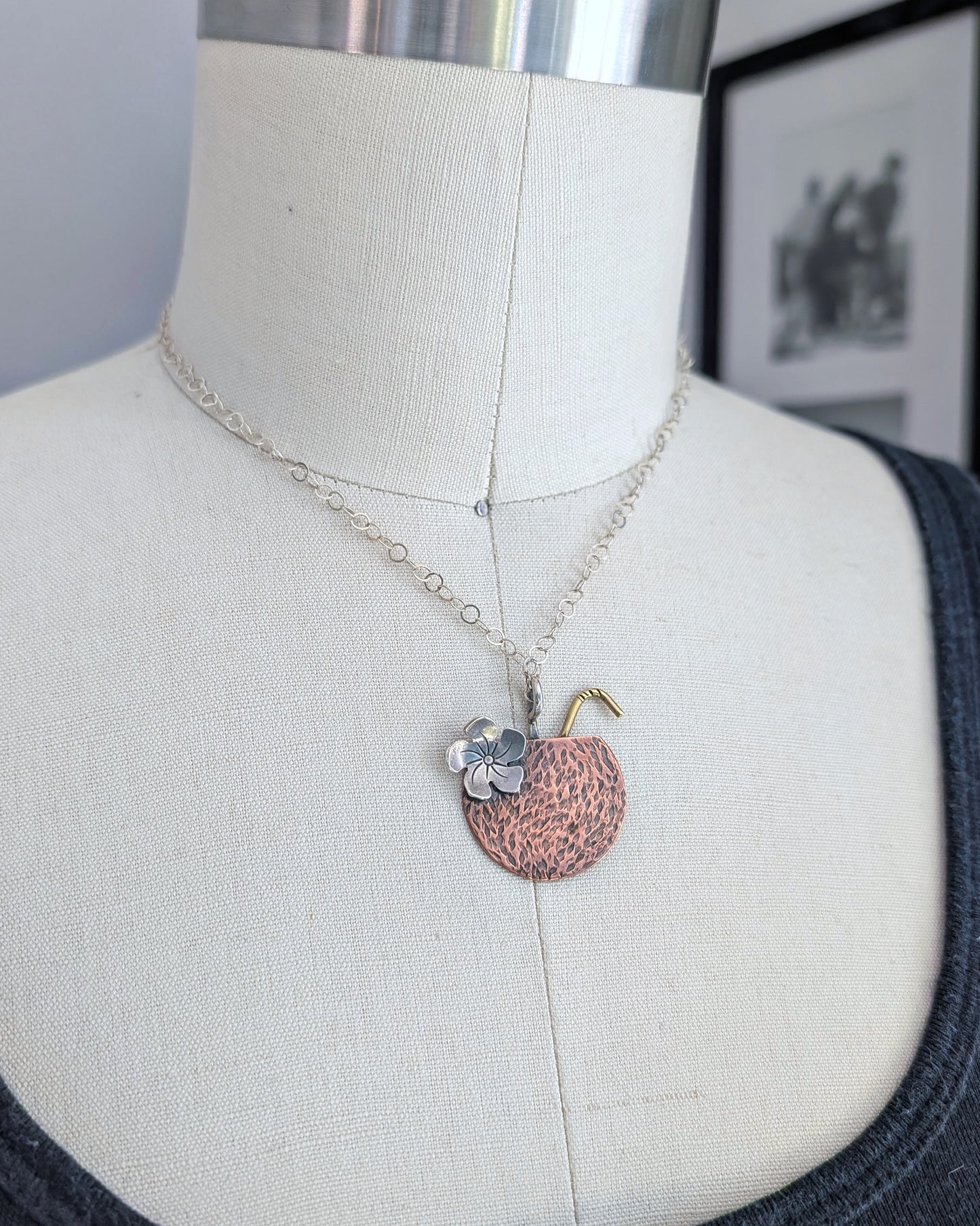 Handmade copper coconut Tiki drink necklace on a dress form
