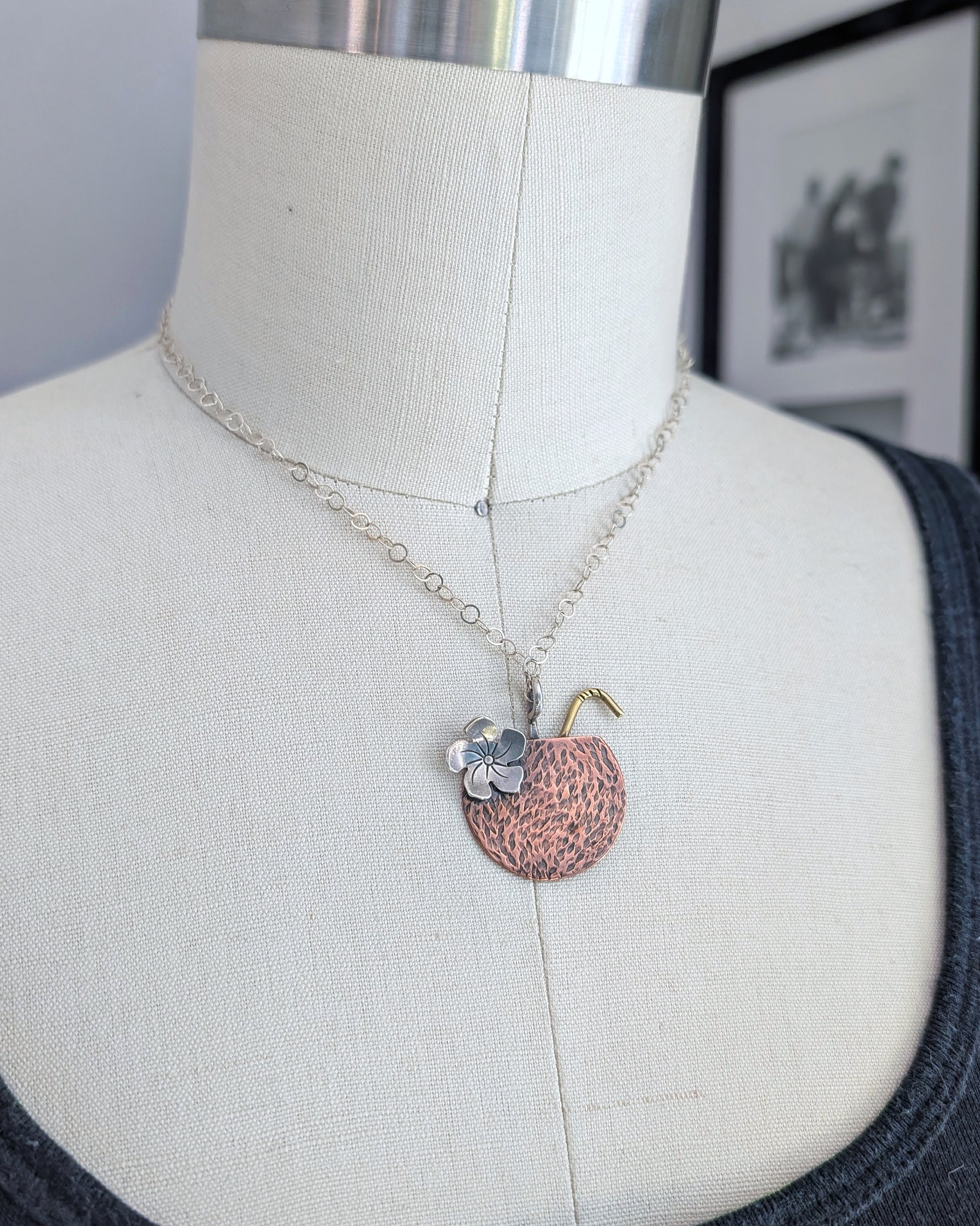 Handmade copper coconut Tiki drink necklace on a dress form