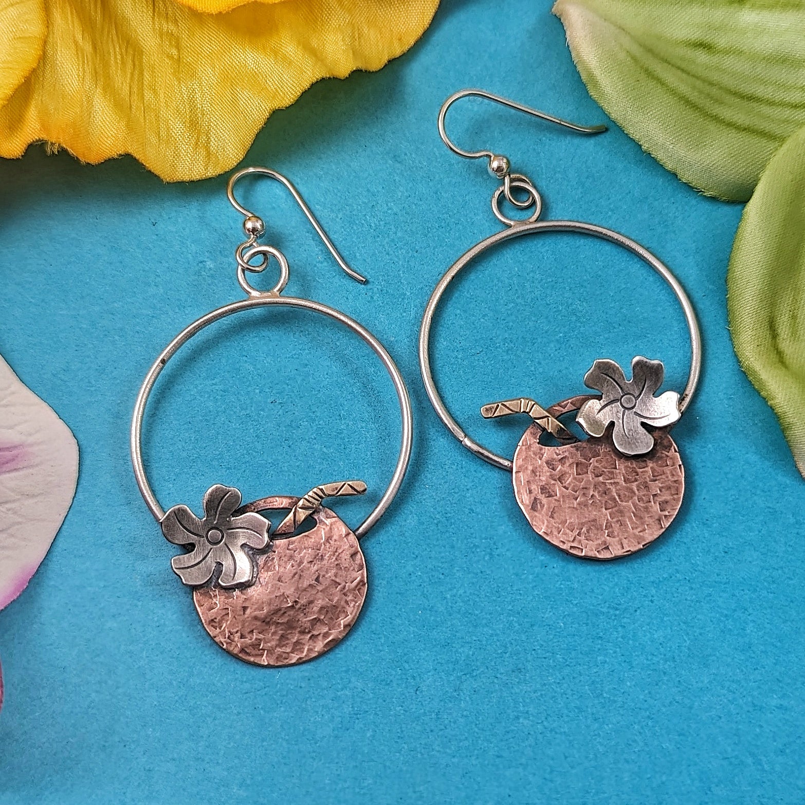 Copper coconut earrings on turquoise background