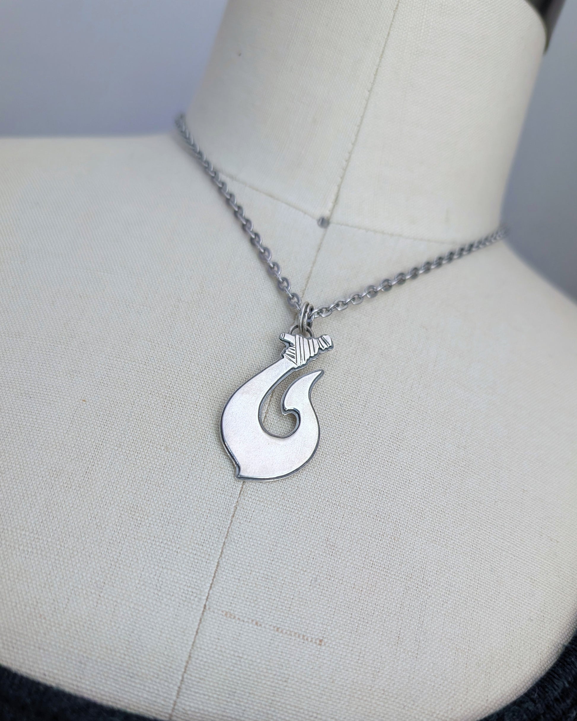Maori Hawaiian sterling silver fish hook necklace on a mannequin