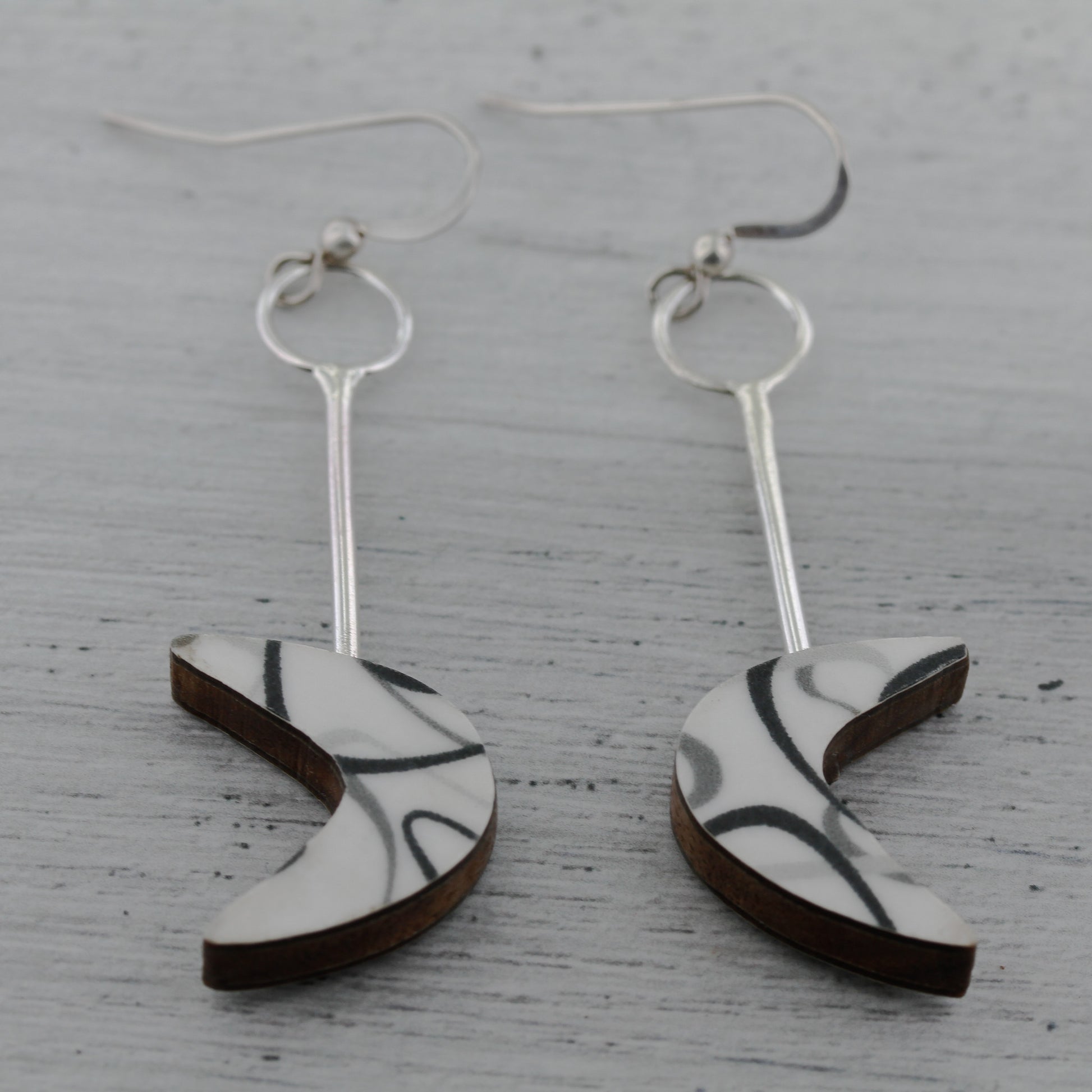 White and black boomerang laminate on wood earrings inspired by mid century modern design.