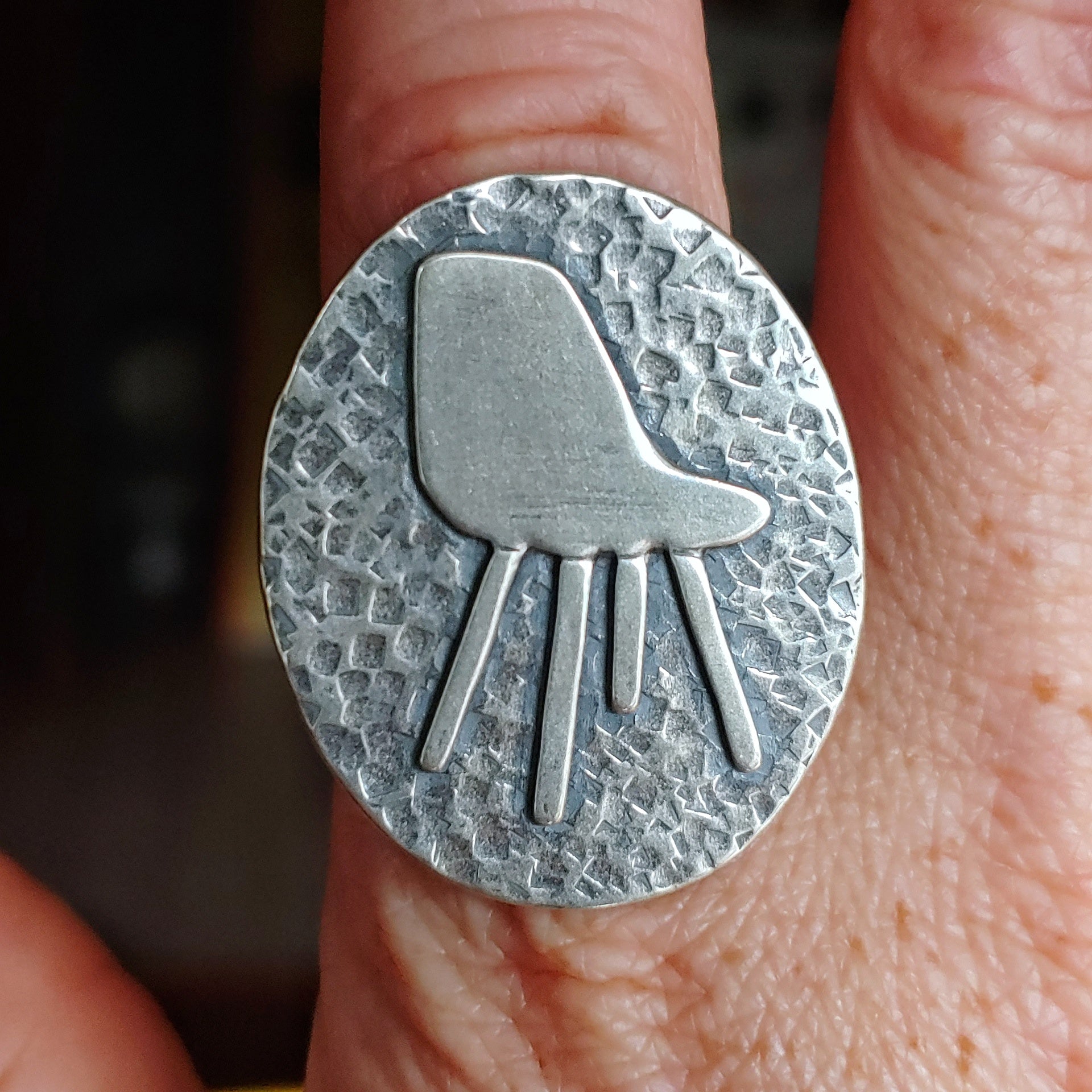 Eames chair ring on finger