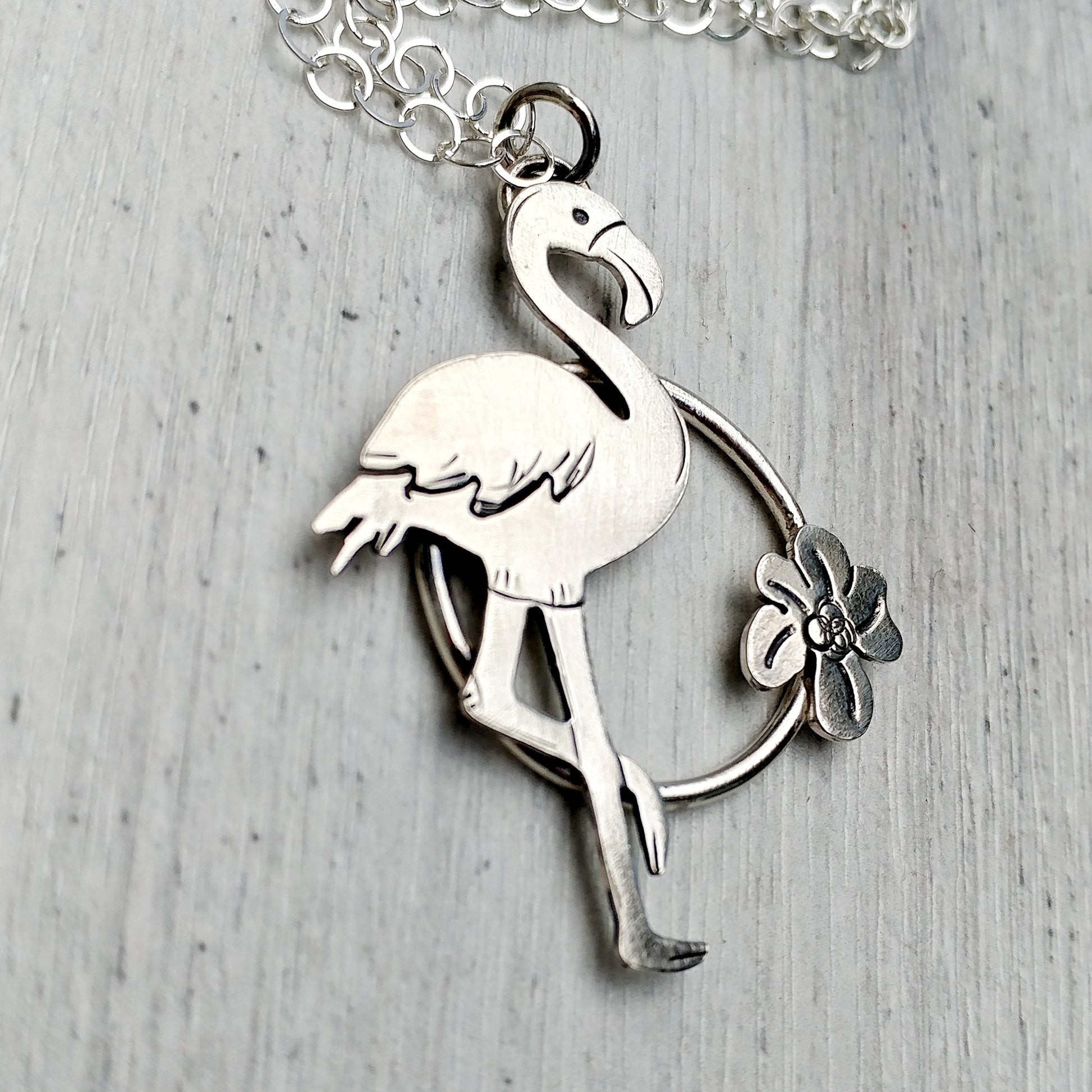 Sterling silver flamingo necklace in a circle with flower
