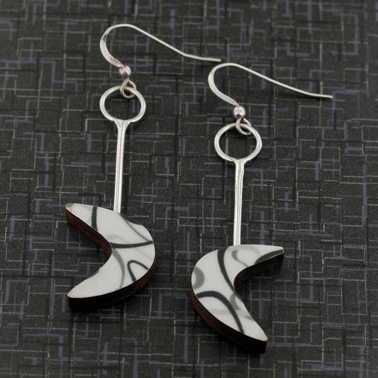 Boomerang laminate earrings in sterling silver on black