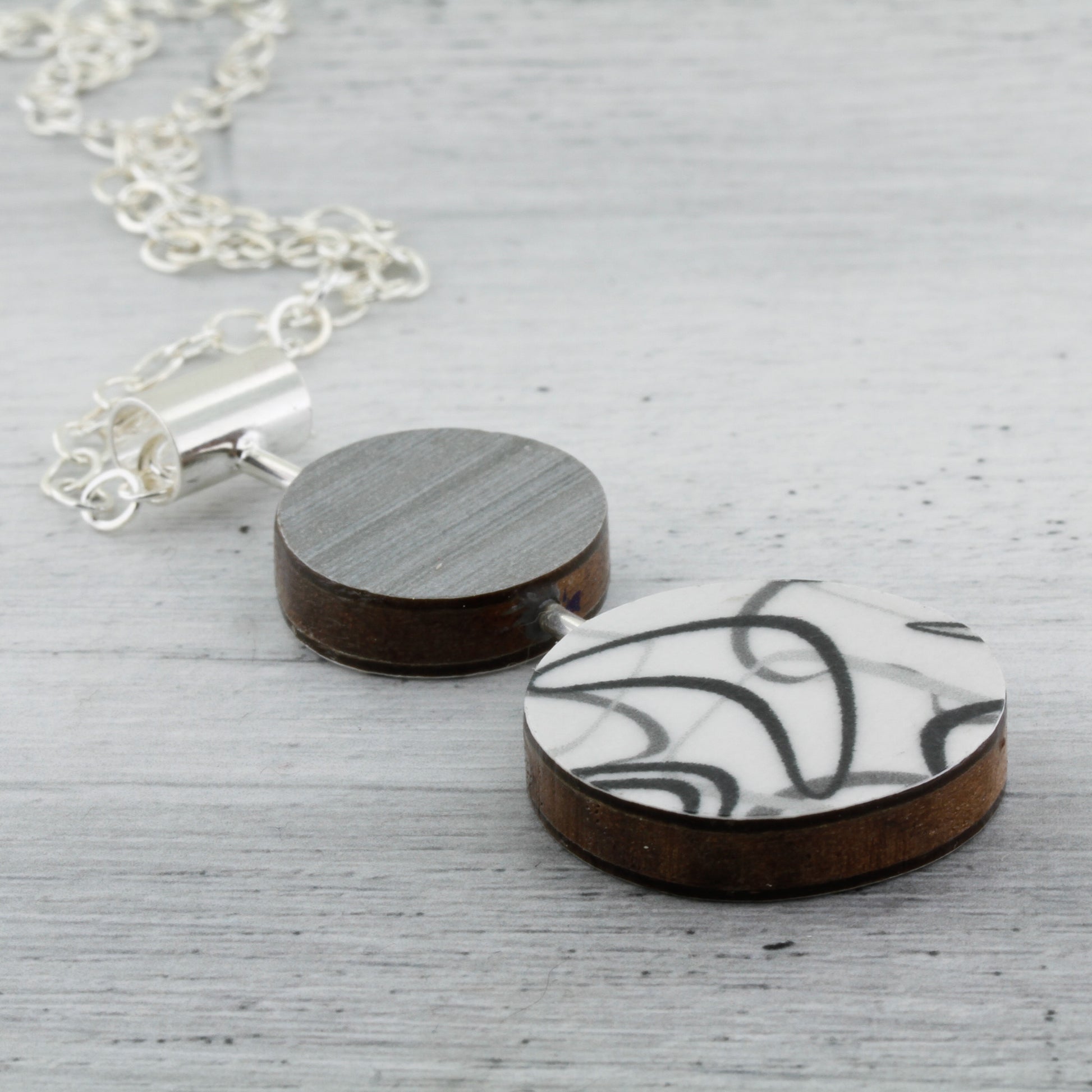 Contemporary art jewelry with laminate on wood boomerang pattern