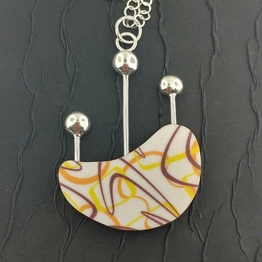 Yellow and orange boomerang laminate kidney shaped necklace
