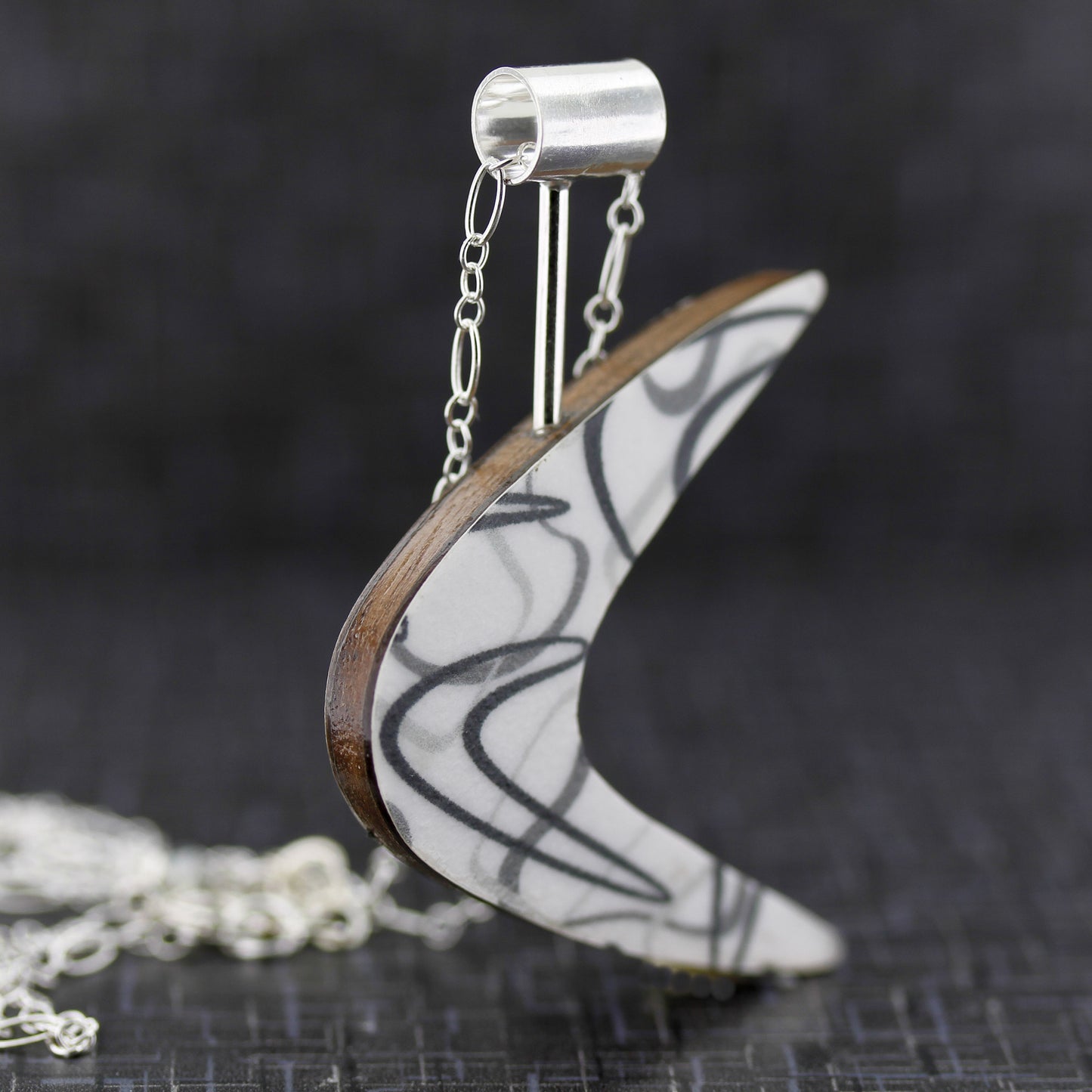 Boomerang shaped laminate on wood necklace inspired by mid century modern art and design.