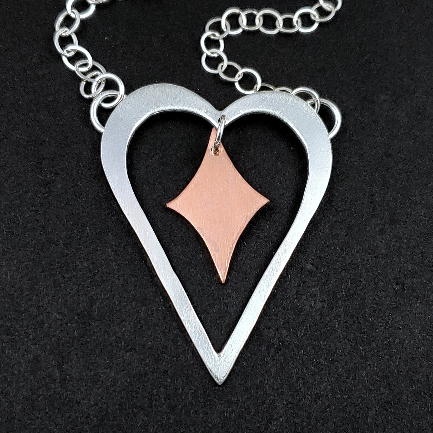 Sterling silver heart shaped necklace with copper retro diamond in the middle
