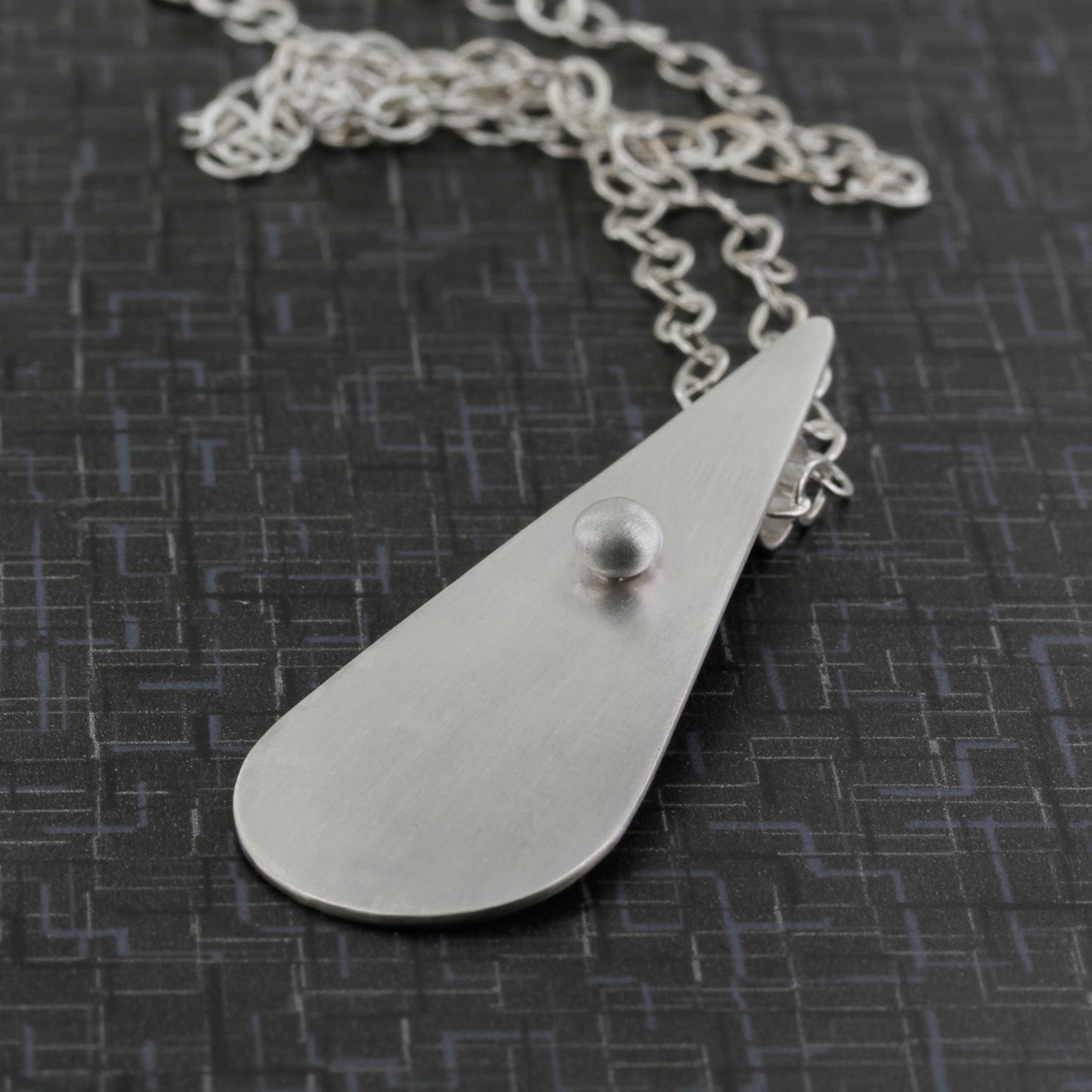 Modernist sterling silver teardrop shaped necklace with sleek lines