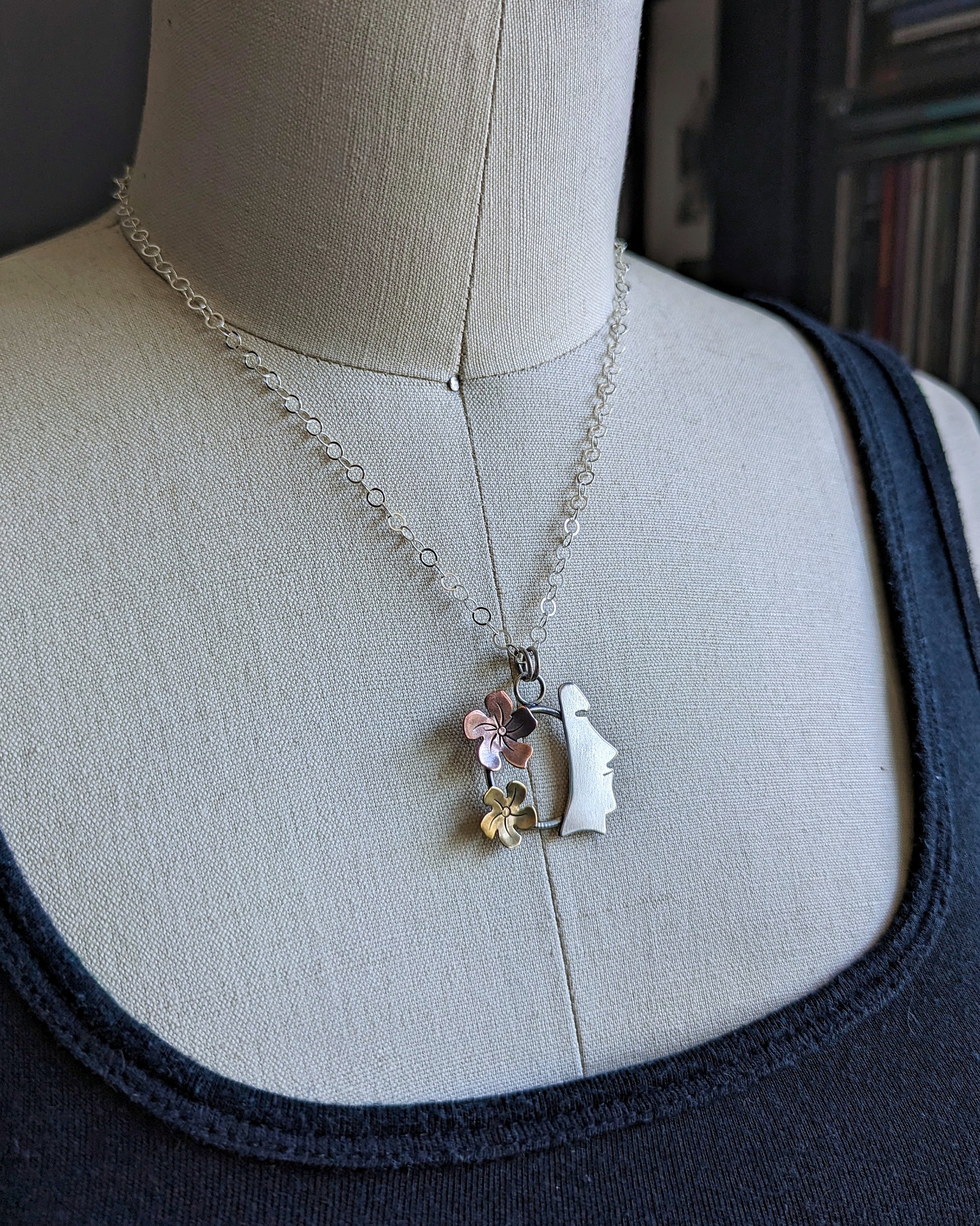 Sterling silver, copper, and brass necklace on a dress form