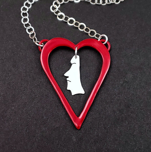 Red heart shaped necklace with sterling silver moai head in the middle