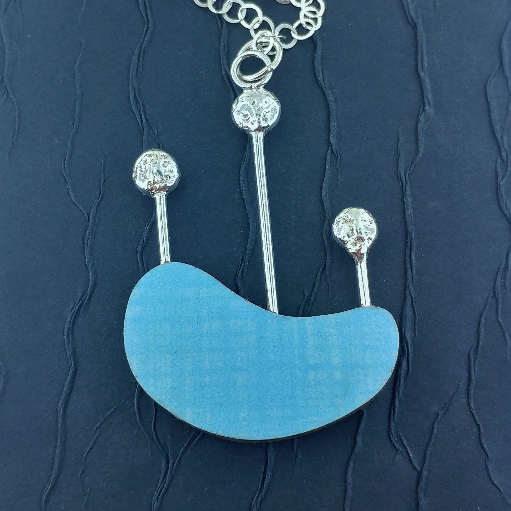Light blue laminate on wood reversible necklace