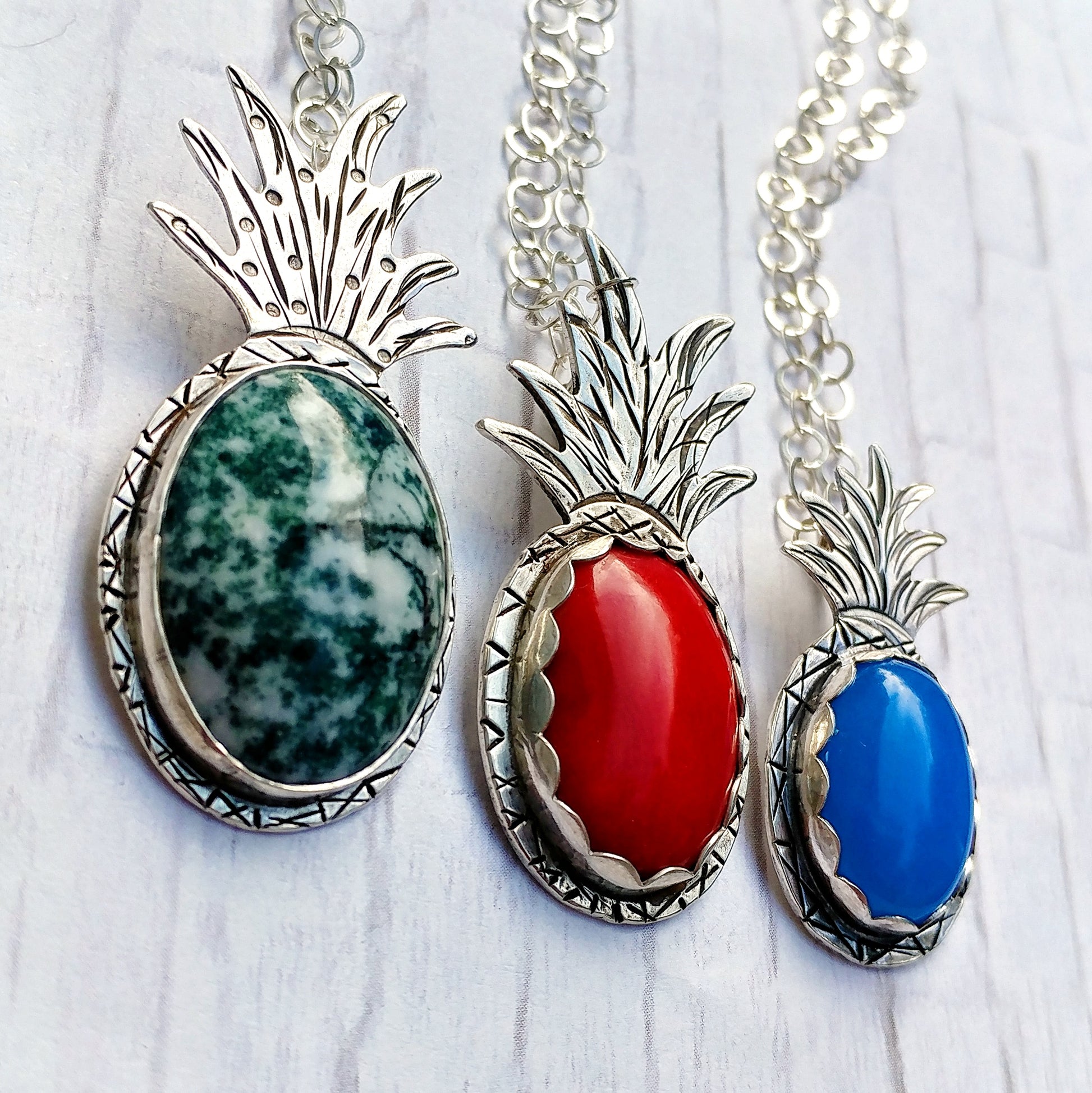 Trio of various gemstones set into a handmade sterling silver pineapple necklace
