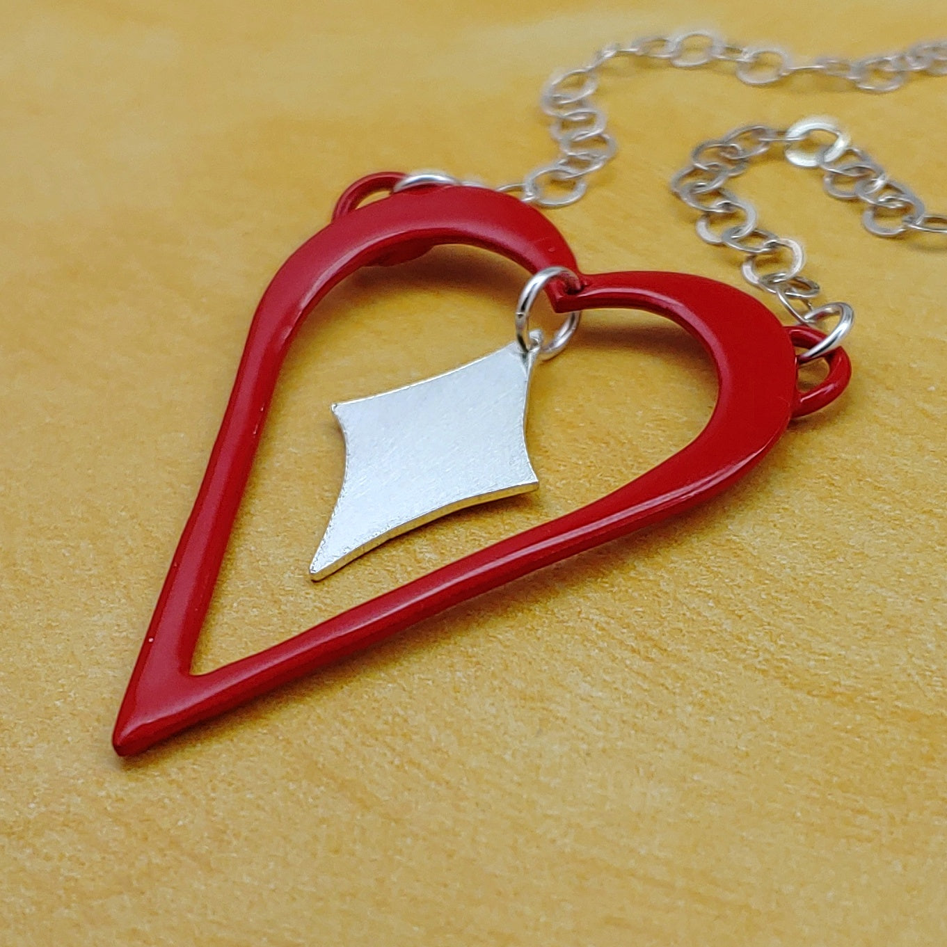 Red heart shaped necklace with sterling silver retro diamond dangling in the middle