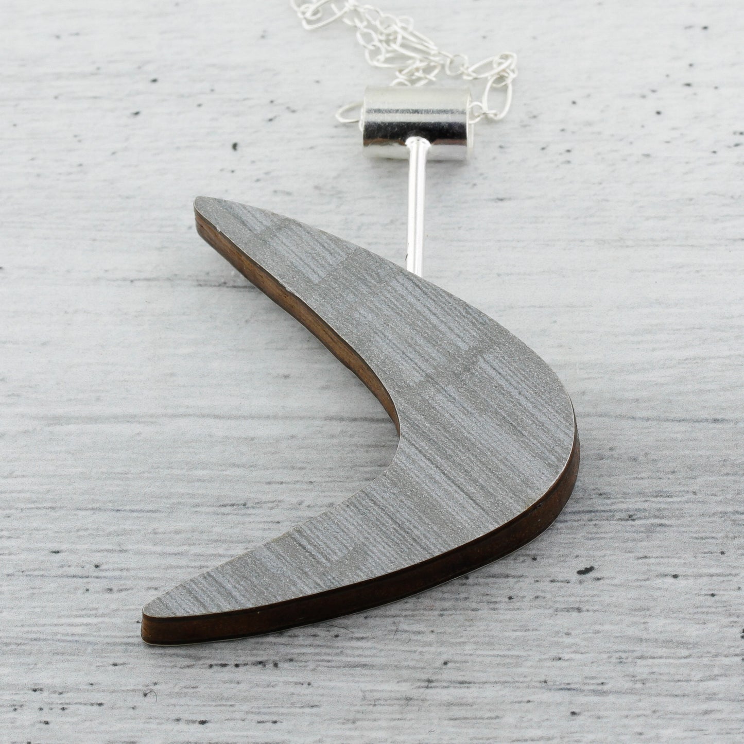 Modernist boomerang shaped laminate on wood necklace.