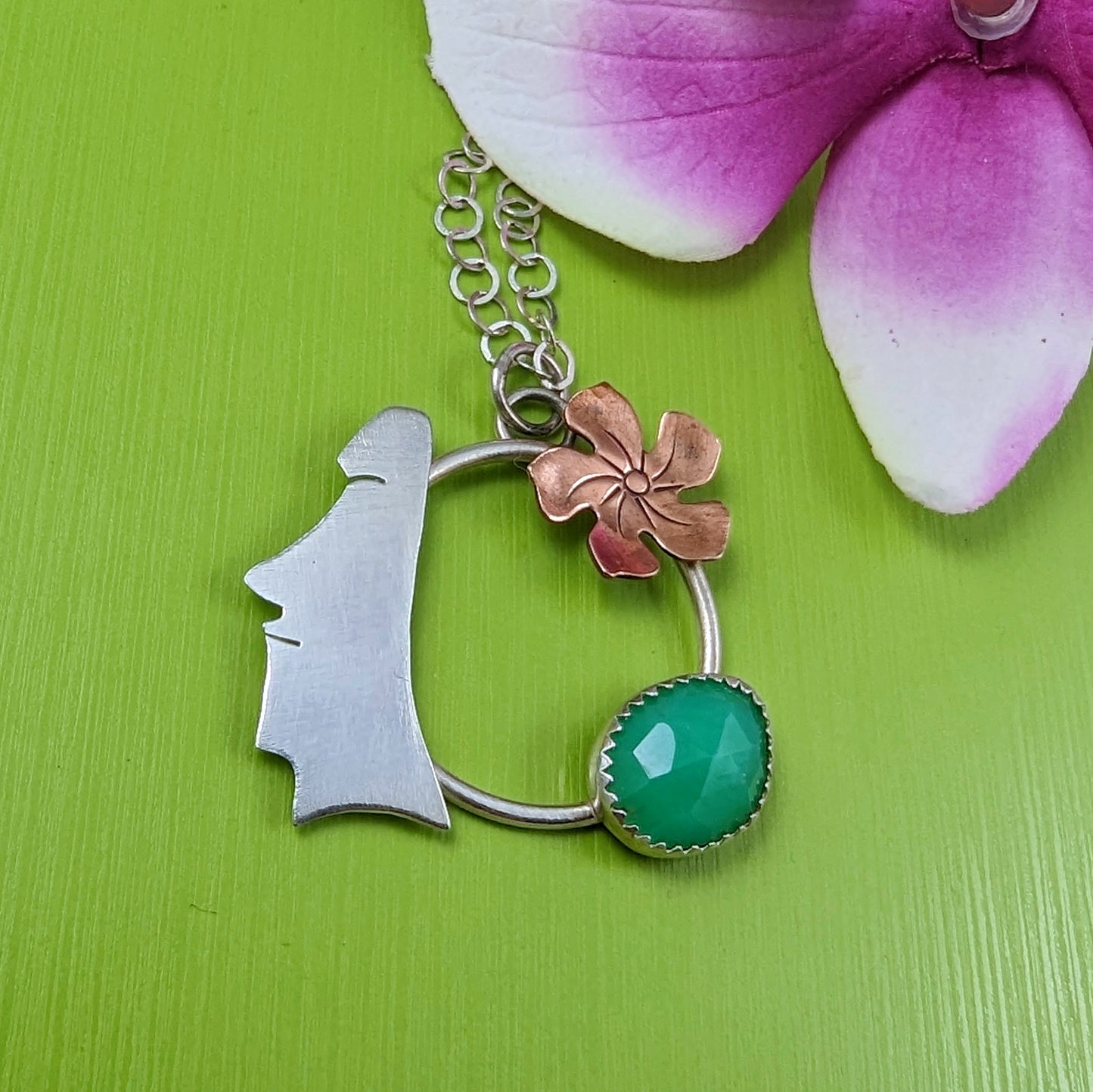 Sterling silver, copper, and chrysoprase necklace on green background